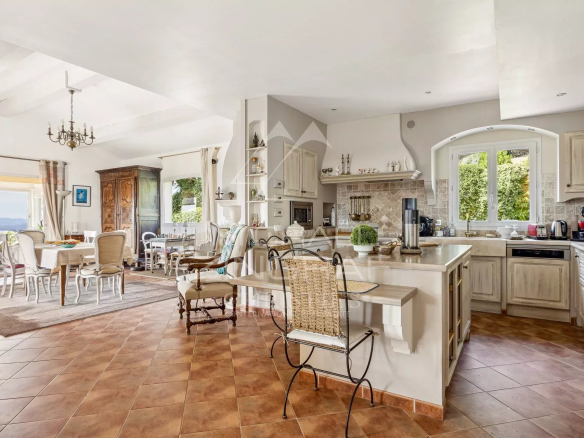 Interior of a Provençal villa with open kitchen and bright living room.
