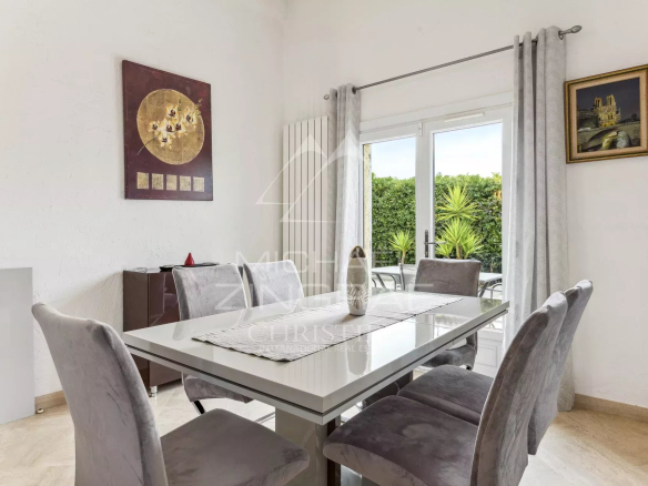 Interior of a family home in Mandelieu-La Napoule with elegant dining room and access to the outside.