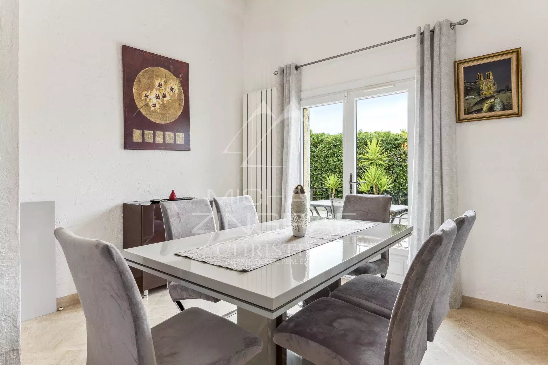 Interior of a family home in Mandelieu-La Napoule with elegant dining room and access to the outside.