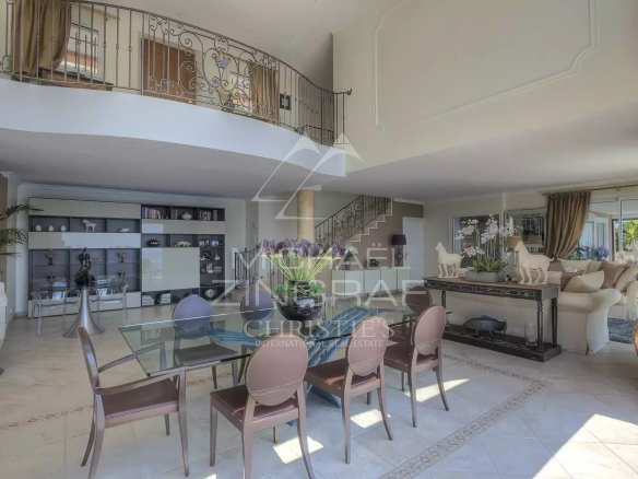 Interior of a spacious villa with dining room and living room, sea view.
