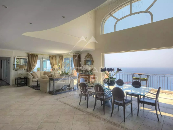 Interior of a villa with sea view, spacious living room and dining room.