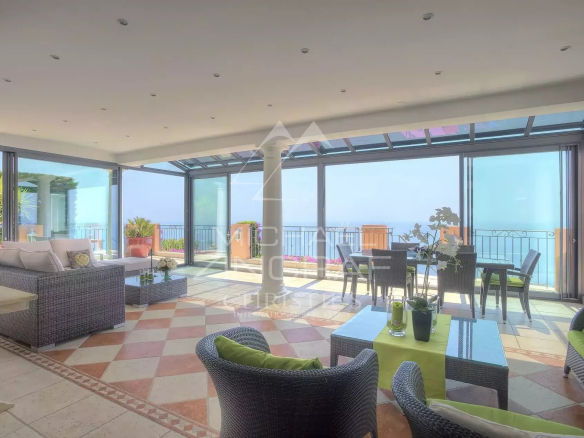 Interior of a villa with sea view, bright living room and modern furniture.