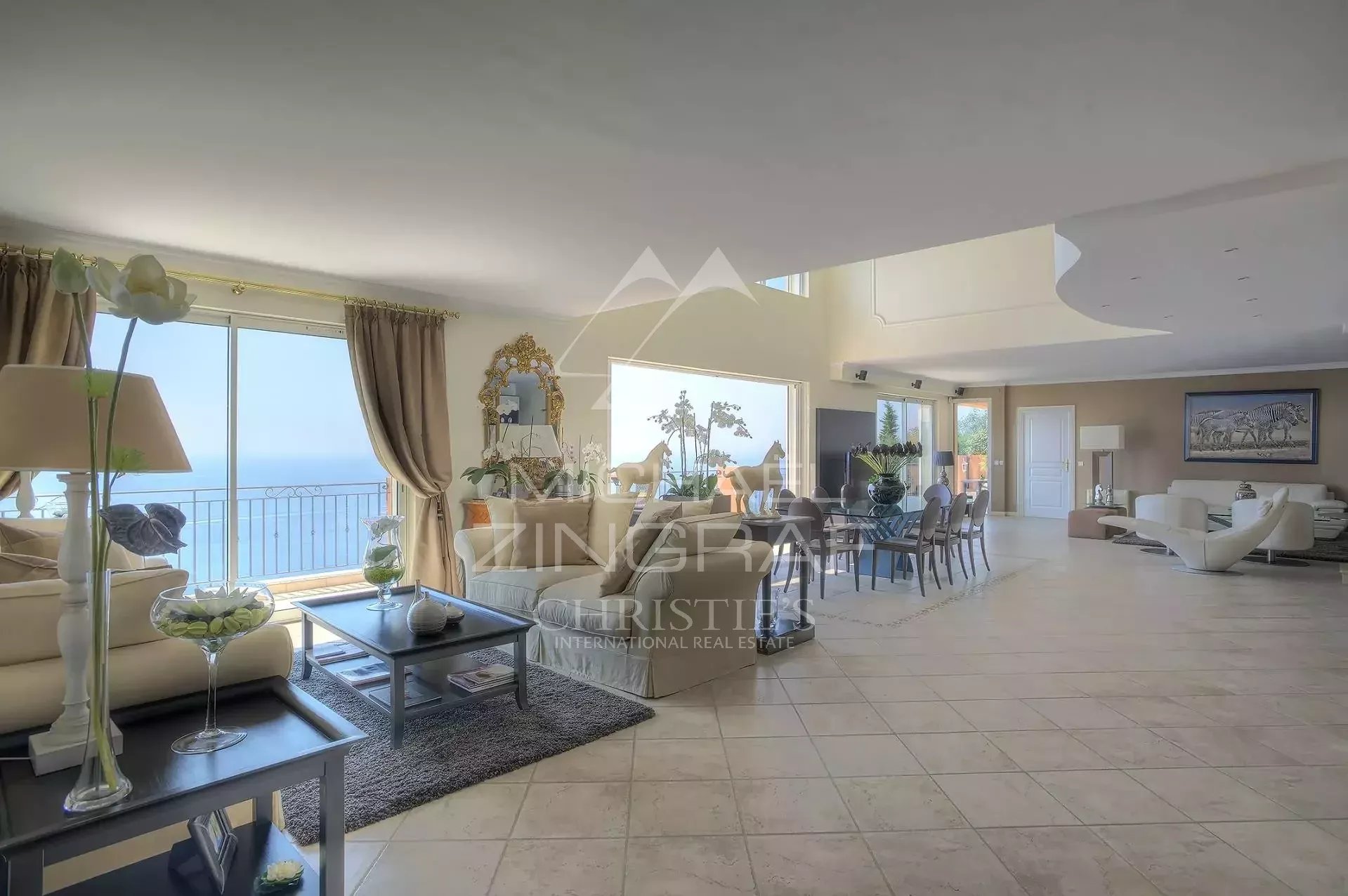 Villa interior with sea view Interior of a spacious villa overlooking the Mediterranean Sea, bright living room and elegant decor.