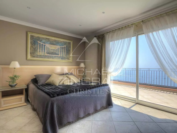 Room with sea view, open windows, elegant decor, natural light