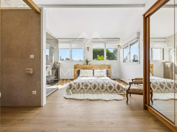 Bright room with double bed and mirror, in a property in Mandelieu-la-Napoule.