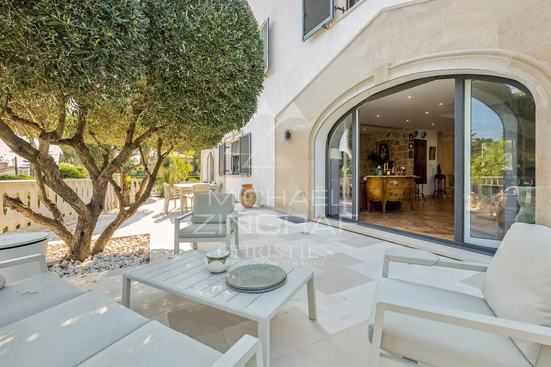 Terrace of a property in Mandelieu-la-Napoule Terrace of an elegant property in Mandelieu-la-Napoule with modern furniture and garden view.