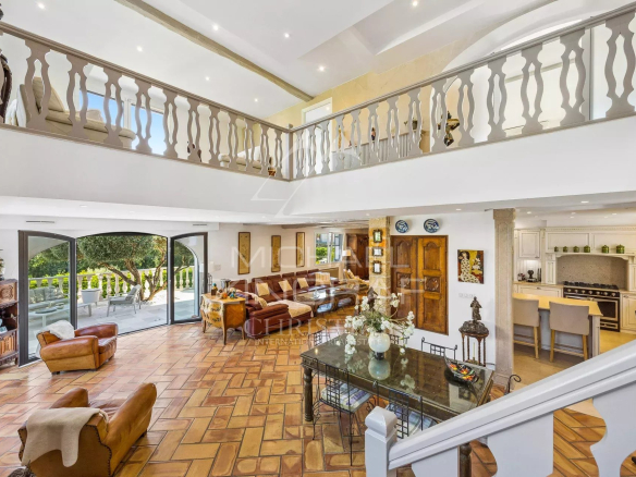 Interior of an elegant property with a spacious living room and open kitchen in Mandelieu-la-Napoule.