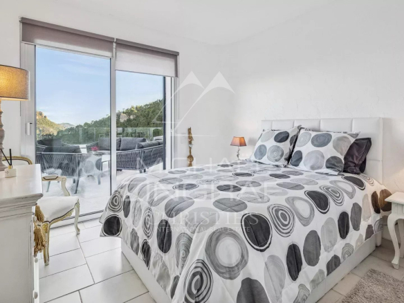 Room with round patterned bed, mountain and sea view in Mandelieu-la-Napoule.