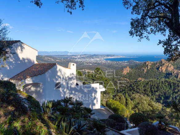 View of a house in a private estate overlooking the sea and mountains in Mandelieu-la-Napoule.