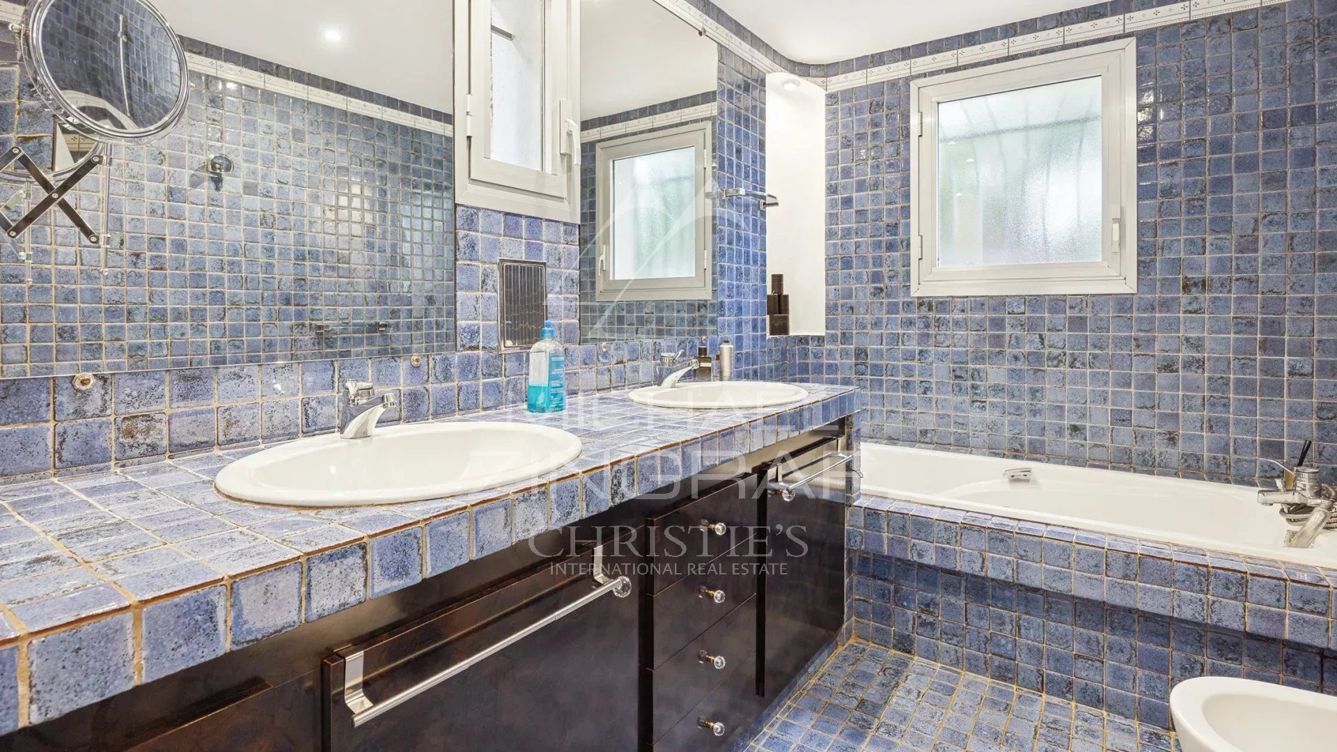 Elegant bathroom Bathroom with blue tiles, double sink and bathtub