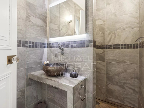 Modern bathroom with shower and stone sink.