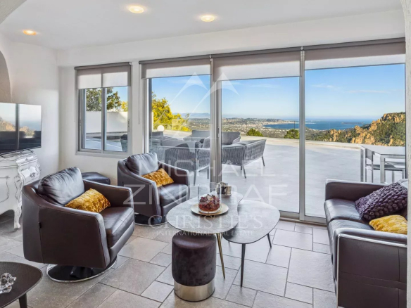 Interior of a house with sea and mountain views, modern and bright living room.
