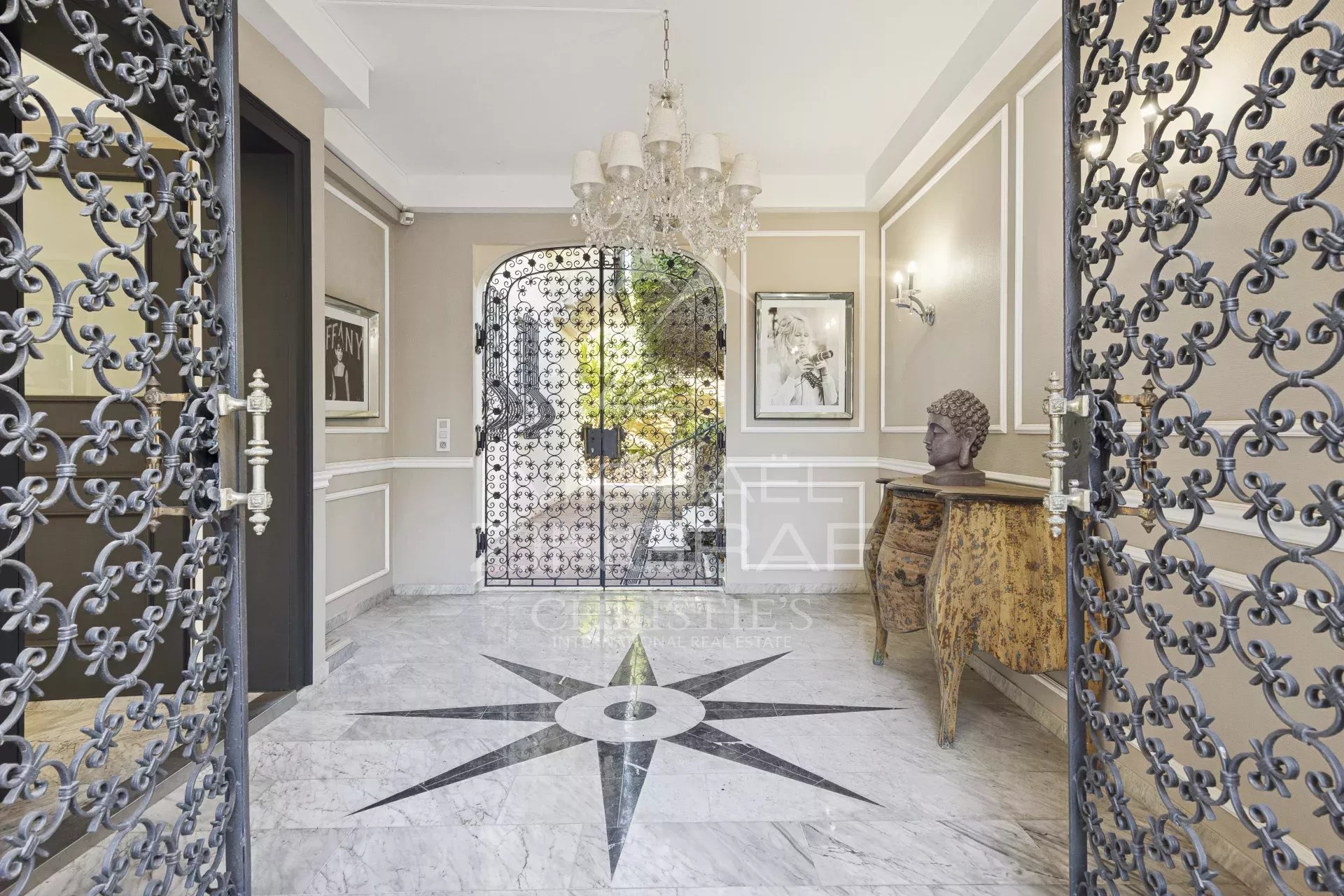 Entrance to a villa in Mandelieu-la-Napoule Entrance to a renovated villa with marble flooring and wrought iron doors in Mandelieu-la-Napoule.
