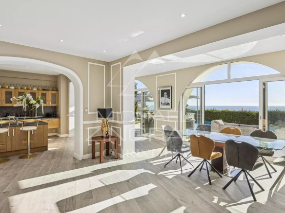 Interior of a renovated villa in Mandelieu-la-Napoule with sea view, bright kitchen and dining room.