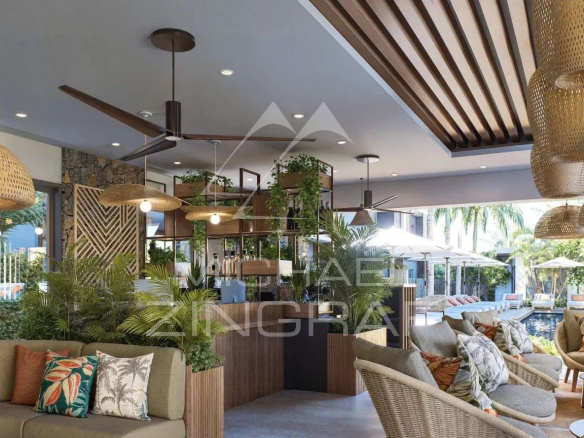 Intérieur d'un penthouse moderne avec mobilier contemporain et décoration végétale à Grand Baie.