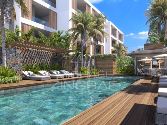 Piscine et espace extérieur d'un penthouse à Grand Baie, entouré de palmiers et de chaises longues.