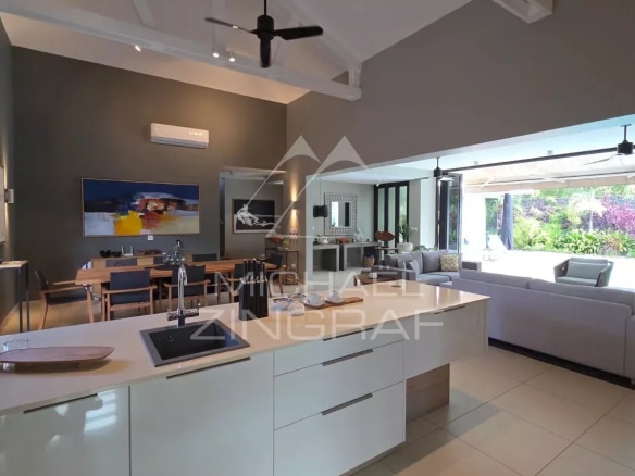 Interior of a contemporary villa in Pereybère with modern kitchen and bright living room.