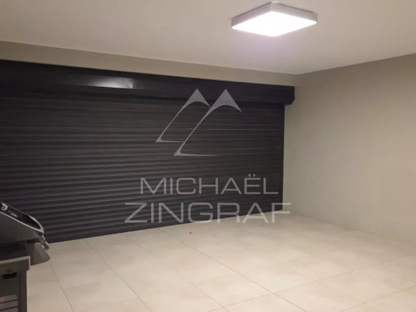 Interior of a contemporary villa in Pereybère with a garage and a barbecue.
