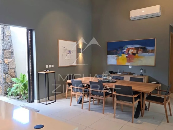Interior of a contemporary villa with dining room and staircase in Pereybère.