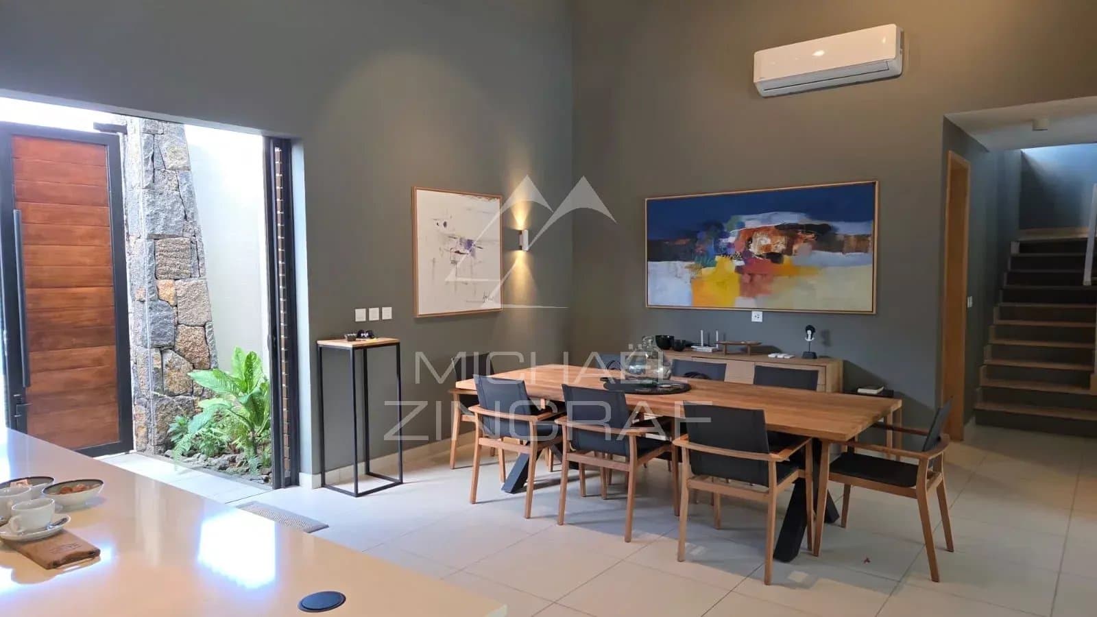Interior of a contemporary villa with dining room and staircase in Pereybère.