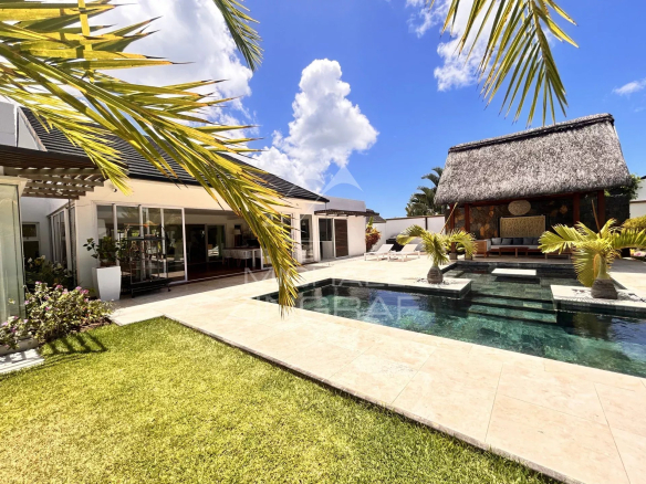 Modern villa with swimming pool and outdoor space in Grand Baie, surrounded by greenery.