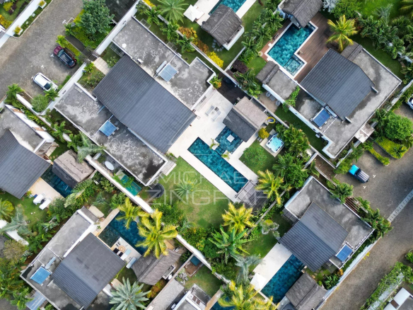 Aerial view of villas with swimming pools and green spaces in Grand Baie, Mauritius.
