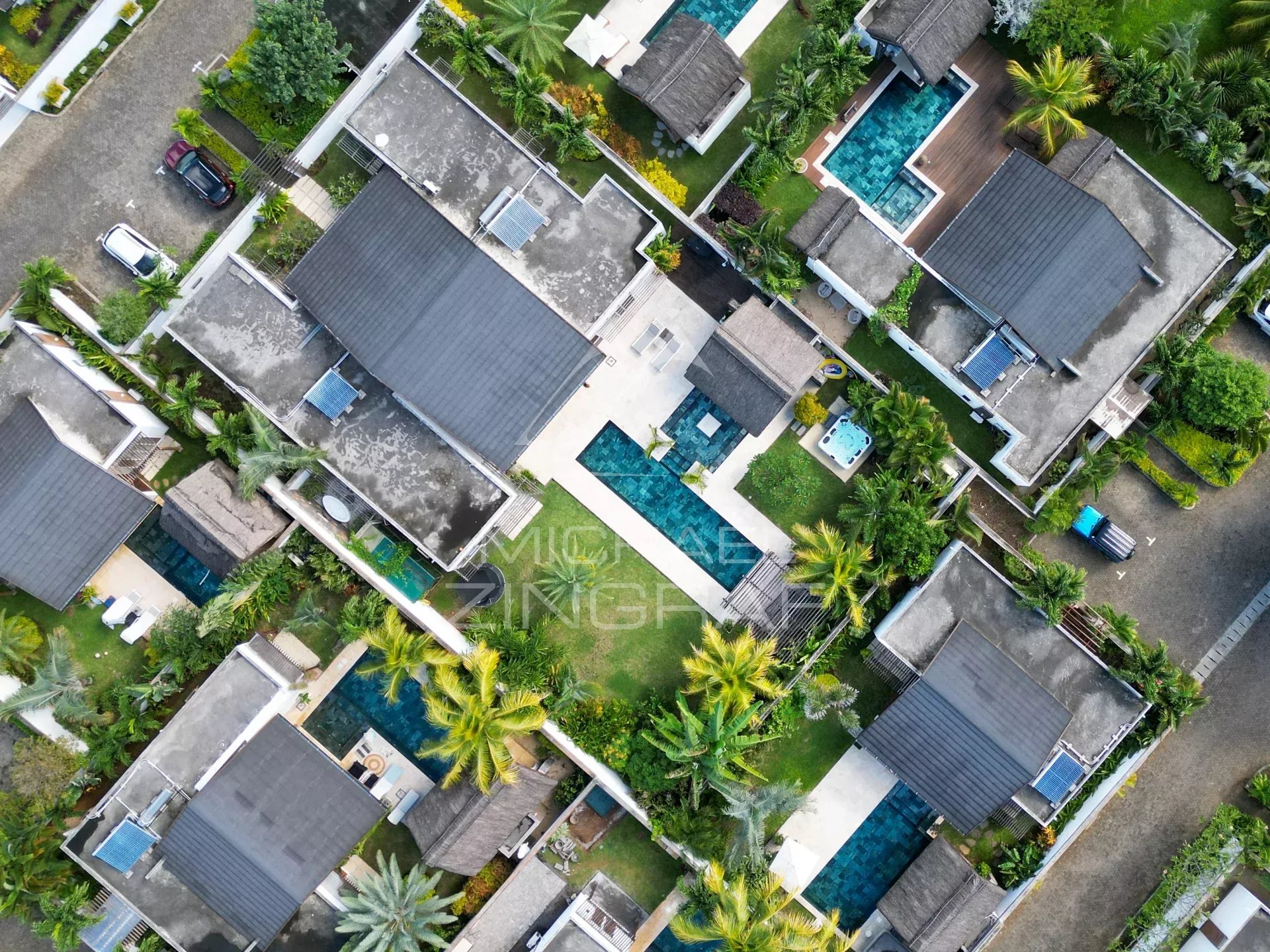 Aerial view of villas with swimming pools and green spaces in Grand Baie, Mauritius.