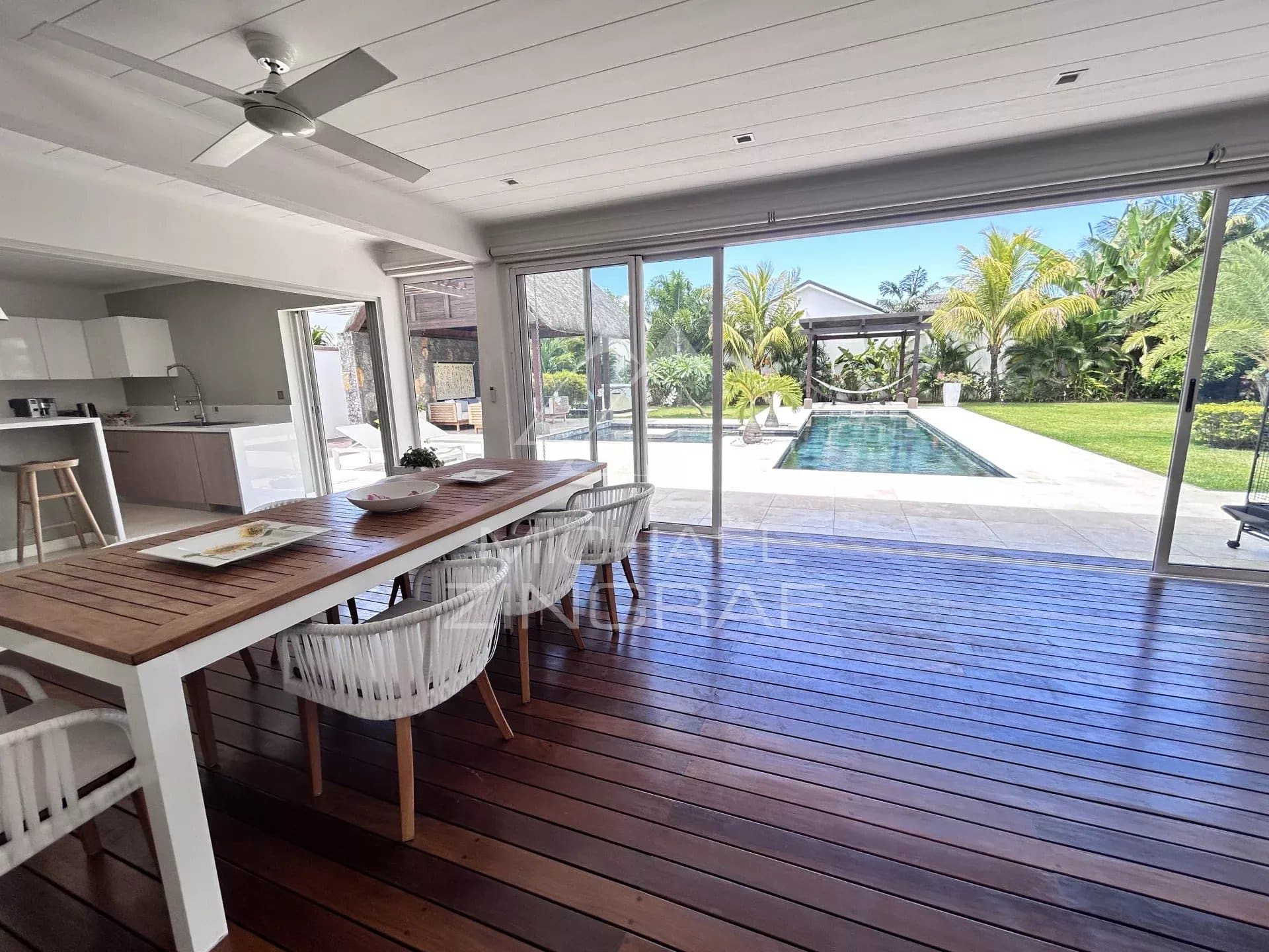 Interior of a modern villa with dining room and pool view