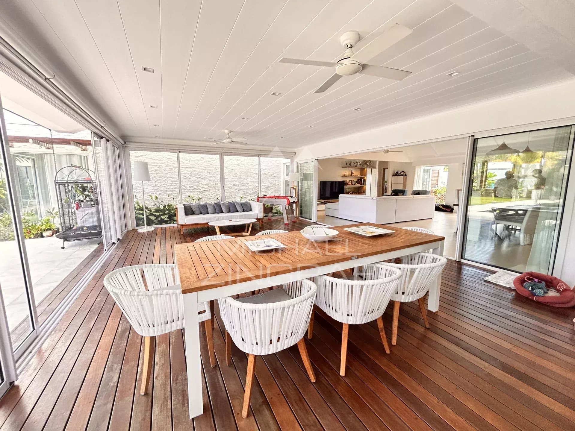 Interior of a modern villa with wooden living and dining room in Grand Baie, Mauritius.