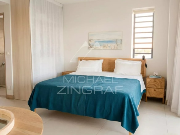 Penthouse room with double bed and modern decor in Pointe aux Canonniers.