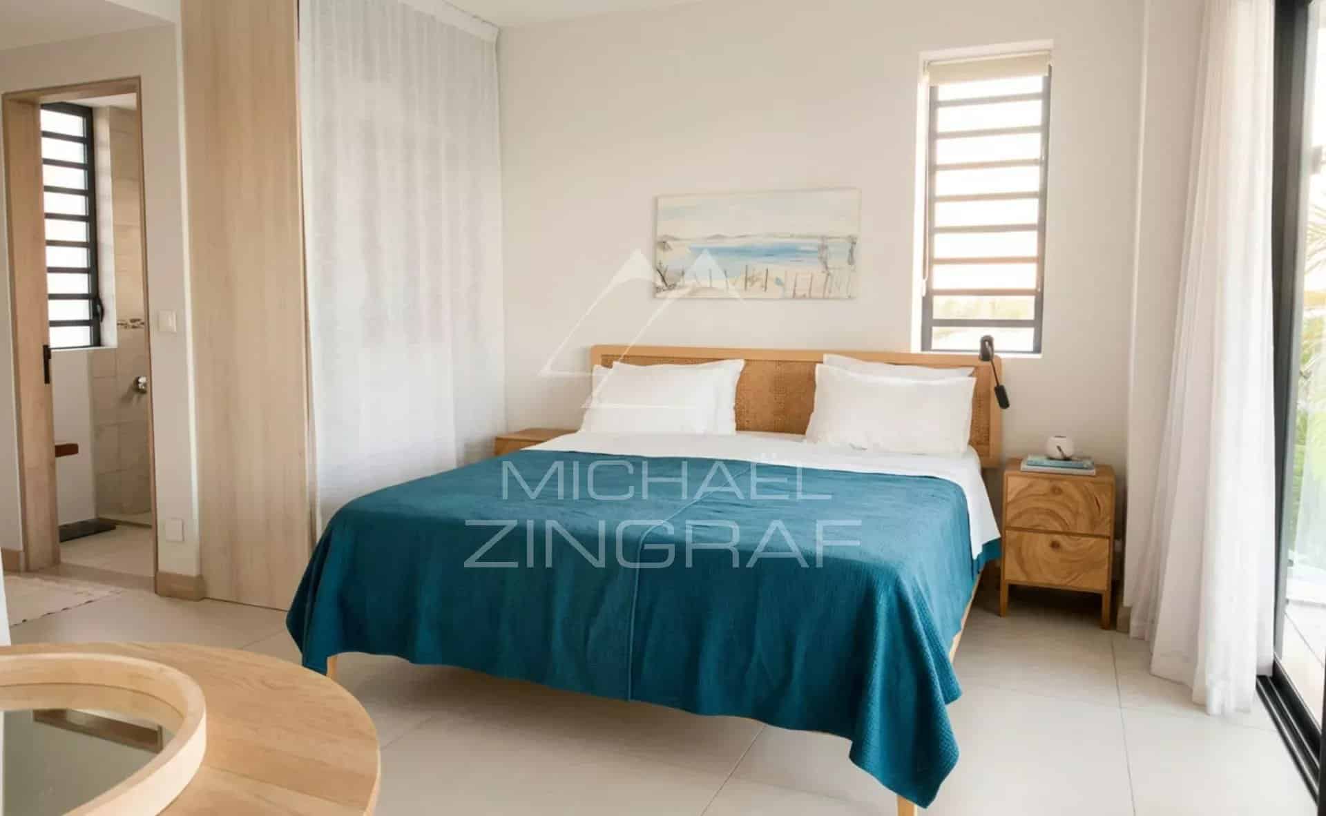 Penthouse bedroom at Pointe aux Canonniers Penthouse room with double bed and modern decor in Pointe aux Canonniers.