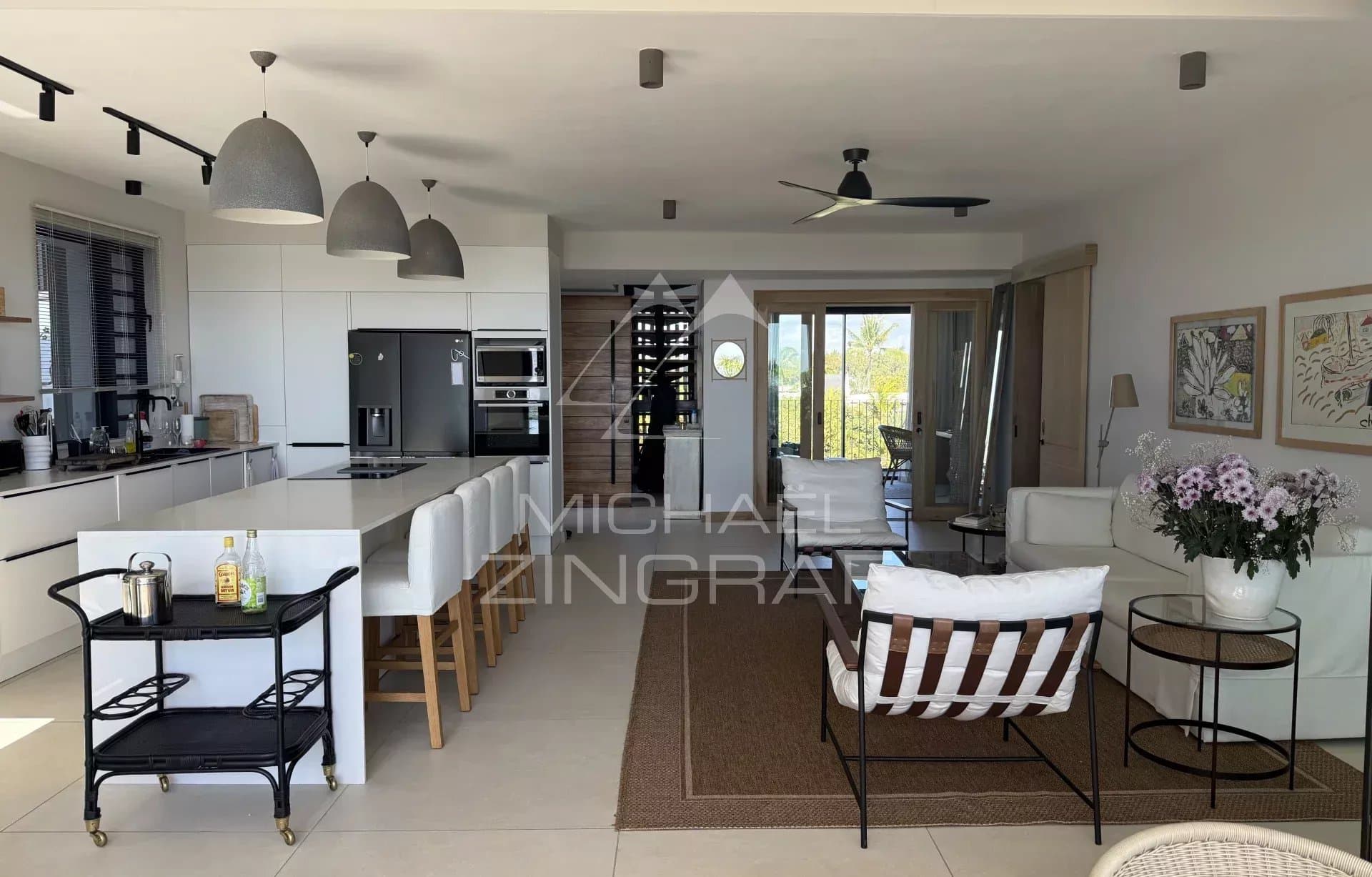 Modern penthouse in Pointe aux Canonniers Interior of a modern penthouse with open kitchen and living room, sea view.