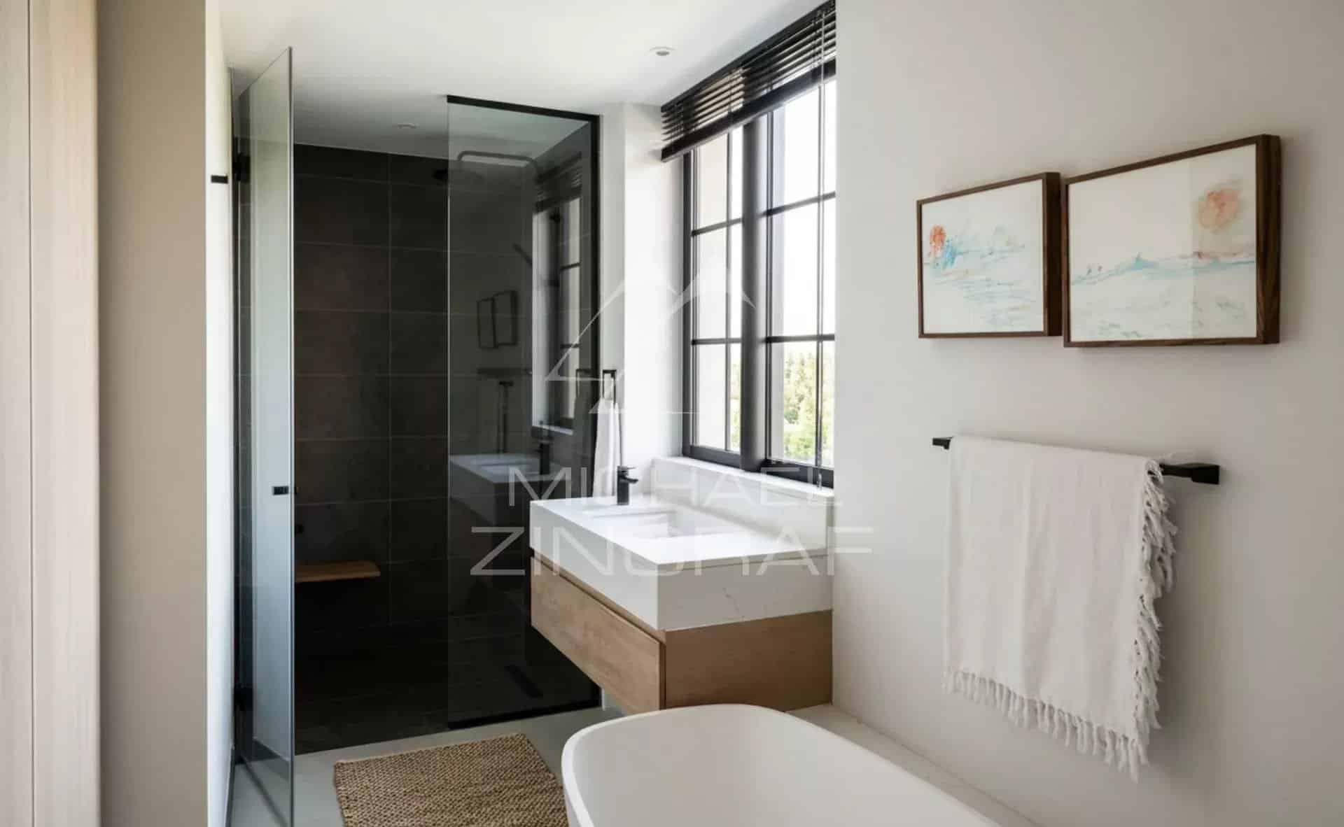 Bathroom in the penthouse at Pointe aux Canonniers Modern bathroom with glass shower and bathtub in a penthouse in Pointe aux Canonniers.