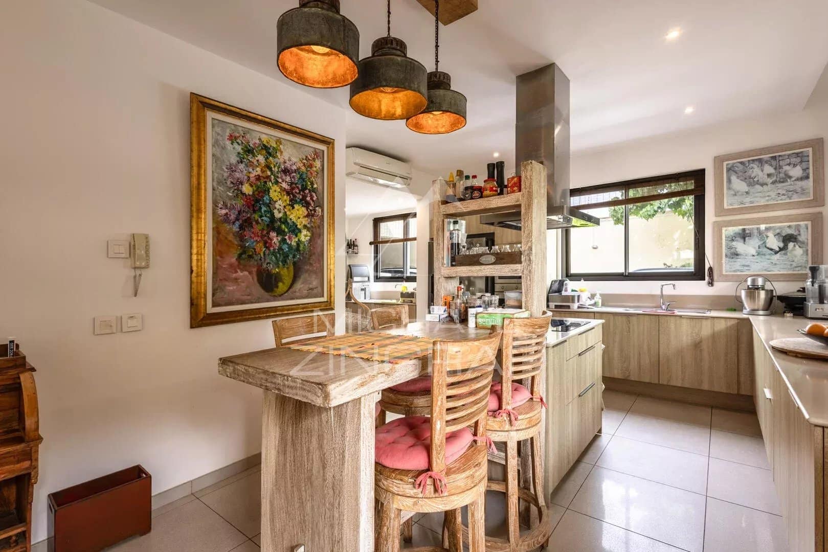 Villa kitchen in Mont Mascal Modern and bright kitchen of a villa in Mont Mascal, Grand Baie, with wooden furniture and pendant lights.