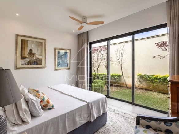 Room in a villa in Mont Mascal, Grand Baie, with a window overlooking a garden.