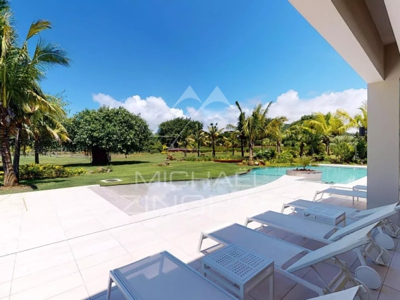 Exterior view of a modern villa with swimming pool and garden in Beau Champ, Mauritius.