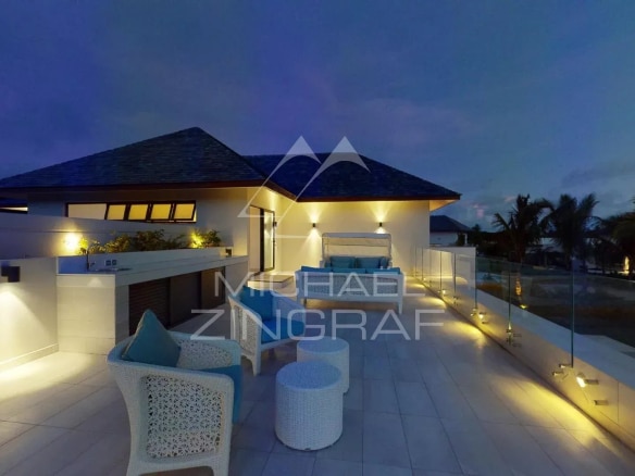 Modern 4-bedroom villa with night lighting, located on a golf course in Beau Champ, Mauritius.