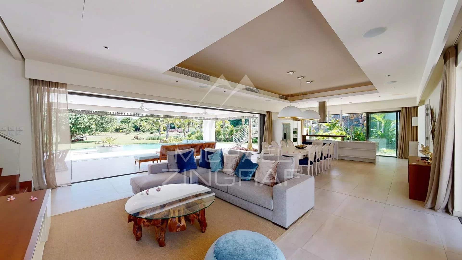 Interior of a modern villa in Mauritius Interior of a modern villa with a spacious living room and bay windows overlooking the garden.