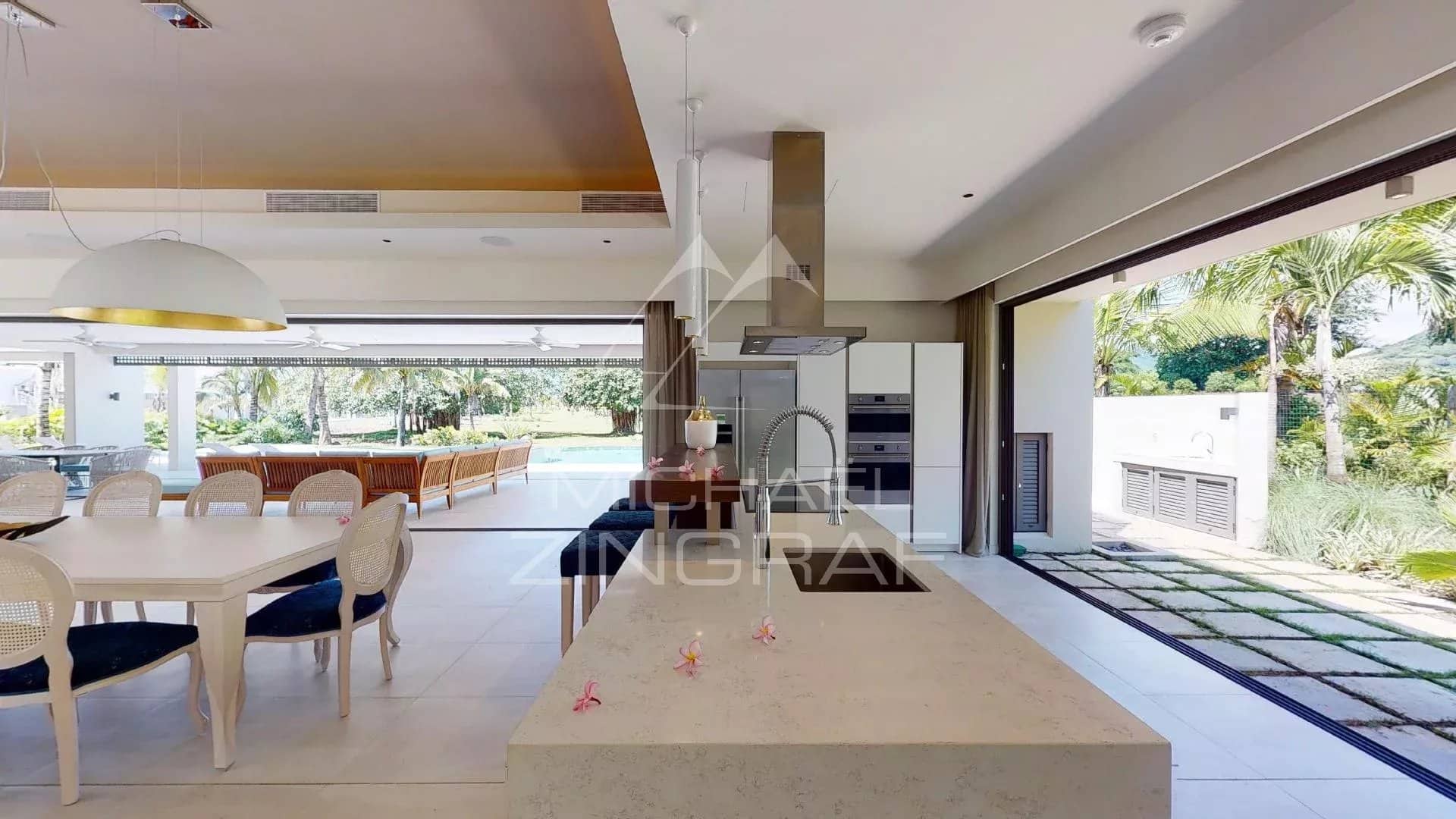 Modern villa in Beau Champ Interior of a modern villa with open kitchen and dining room, overlooking the garden.
