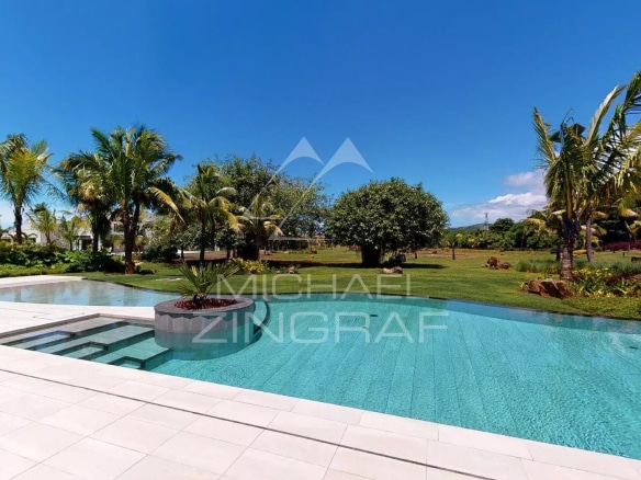 View of the pool and garden of a modern villa in Beau Champ, Mauritius.