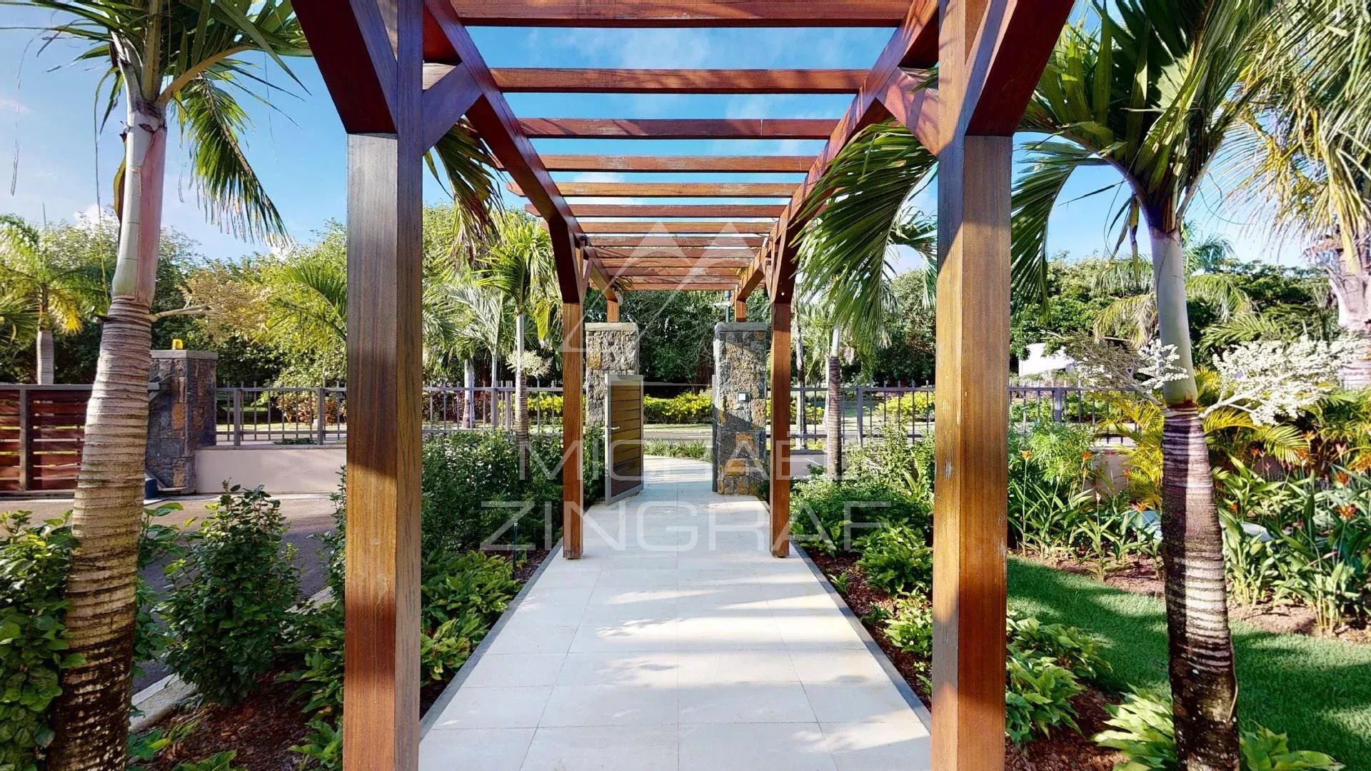 Driveway to a modern villa in Beau Champ Wooden walkway leading to a modern villa surrounded by greenery in Beau Champ, Mauritius.
