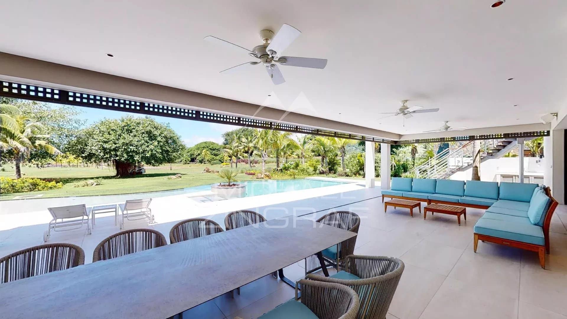 Terrace of a modern villa in Beau Champ Spacious terrace of a modern villa with outdoor furniture and garden view.