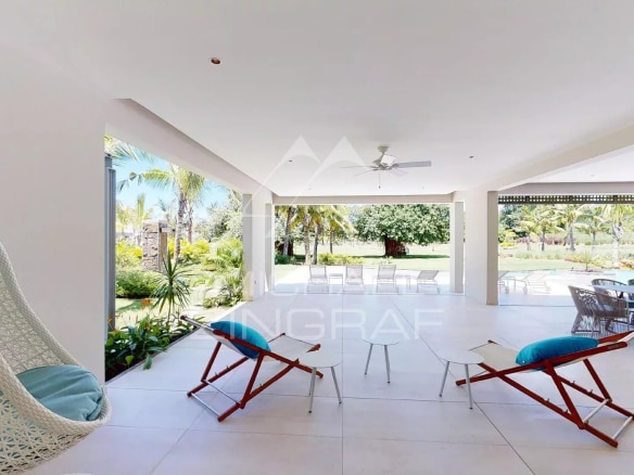 Interior of a modern villa with open living space and comfortable furniture.