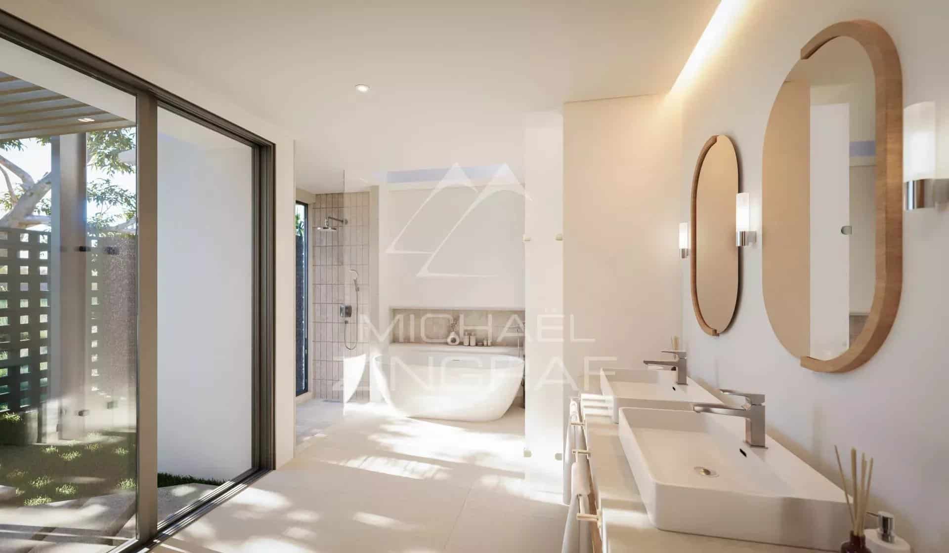 Salle de bain moderne avec baignoire et double vasque, lumière naturelle à Rivière Noire, Île Maurice.