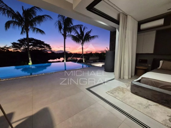 Interior of a contemporary villa with views of the pool and sunset.