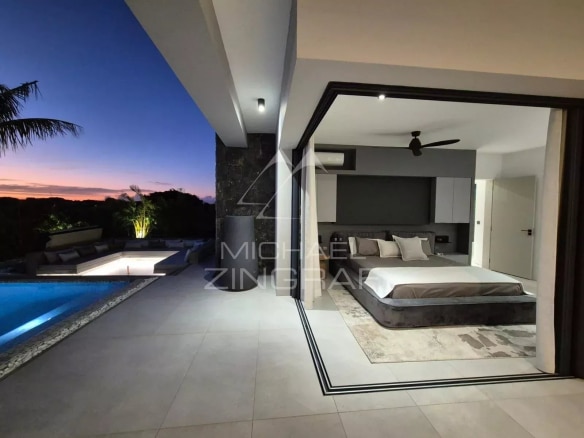 Modern room with pool and outdoor views at Mon Choisy Golf, Grand Baie.