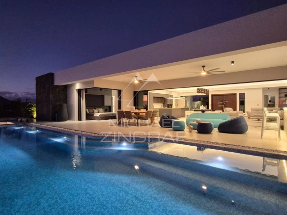 Contemporary villa with swimming pool in Mon Choisy Golf, Grand Baie, night view of the terrace and pool.