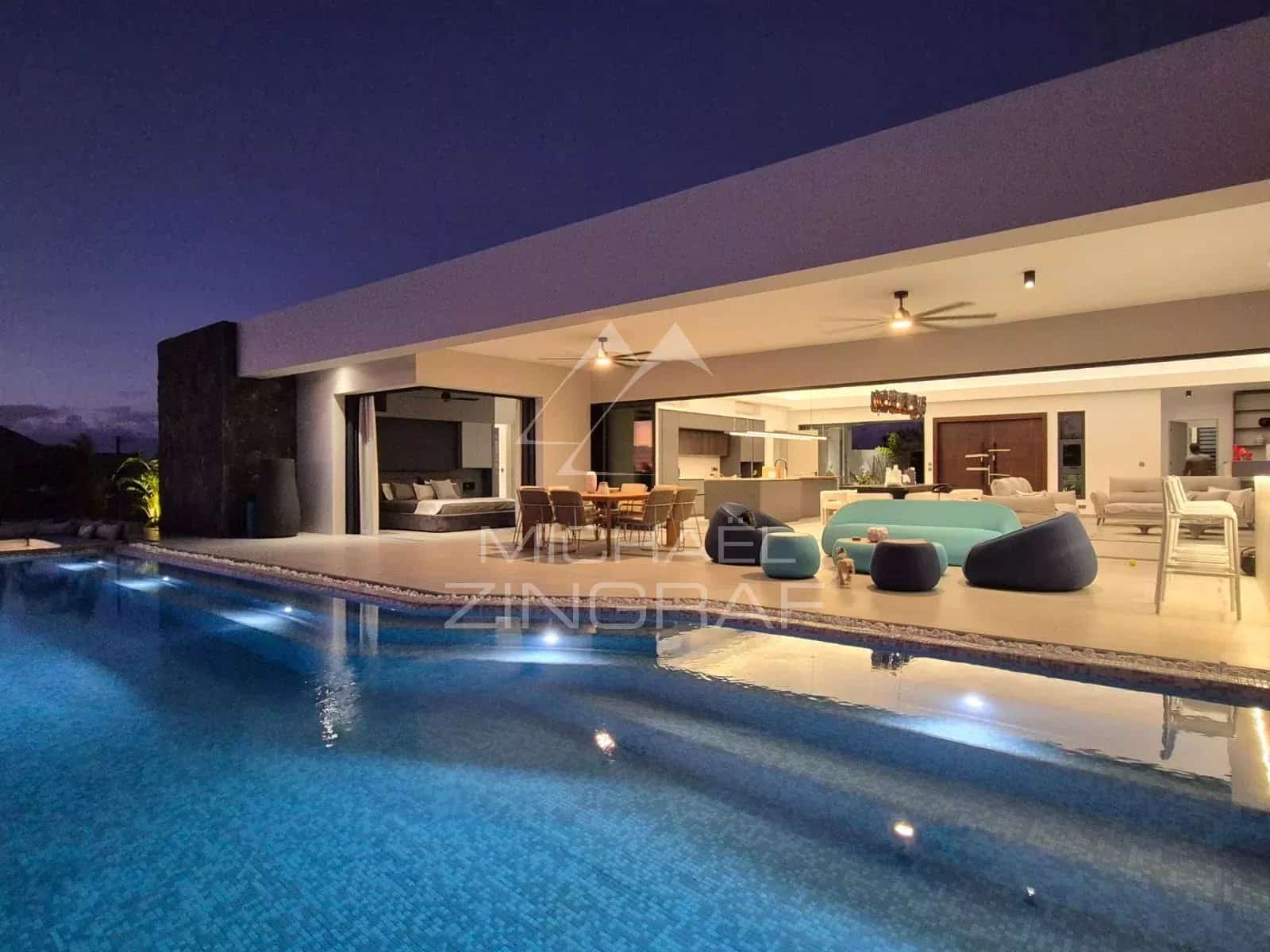Contemporary villa with swimming pool in Mon Choisy Golf, Grand Baie, night view of the terrace and pool.