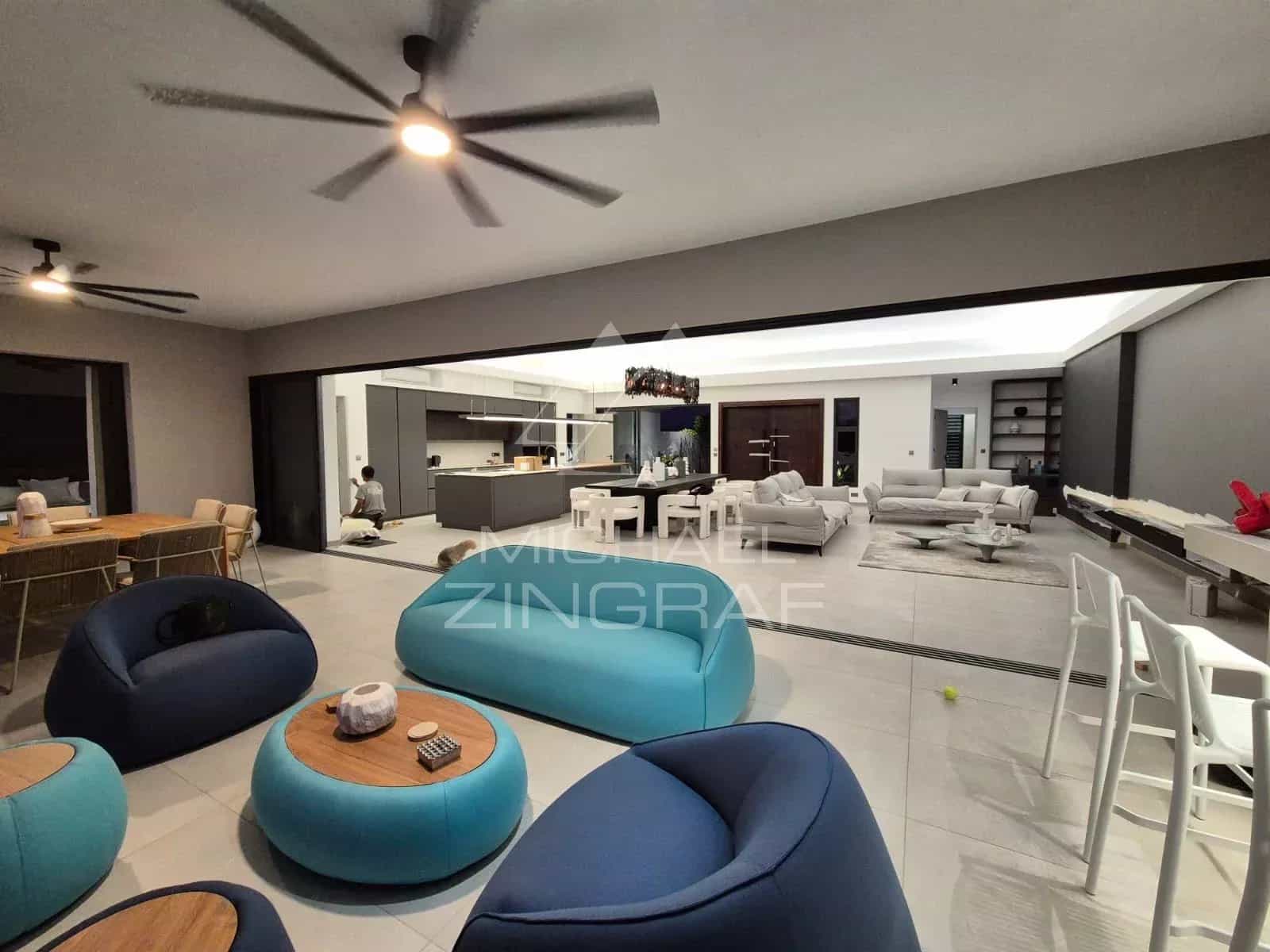 Interior of a contemporary villa with a spacious living room and open kitchen.