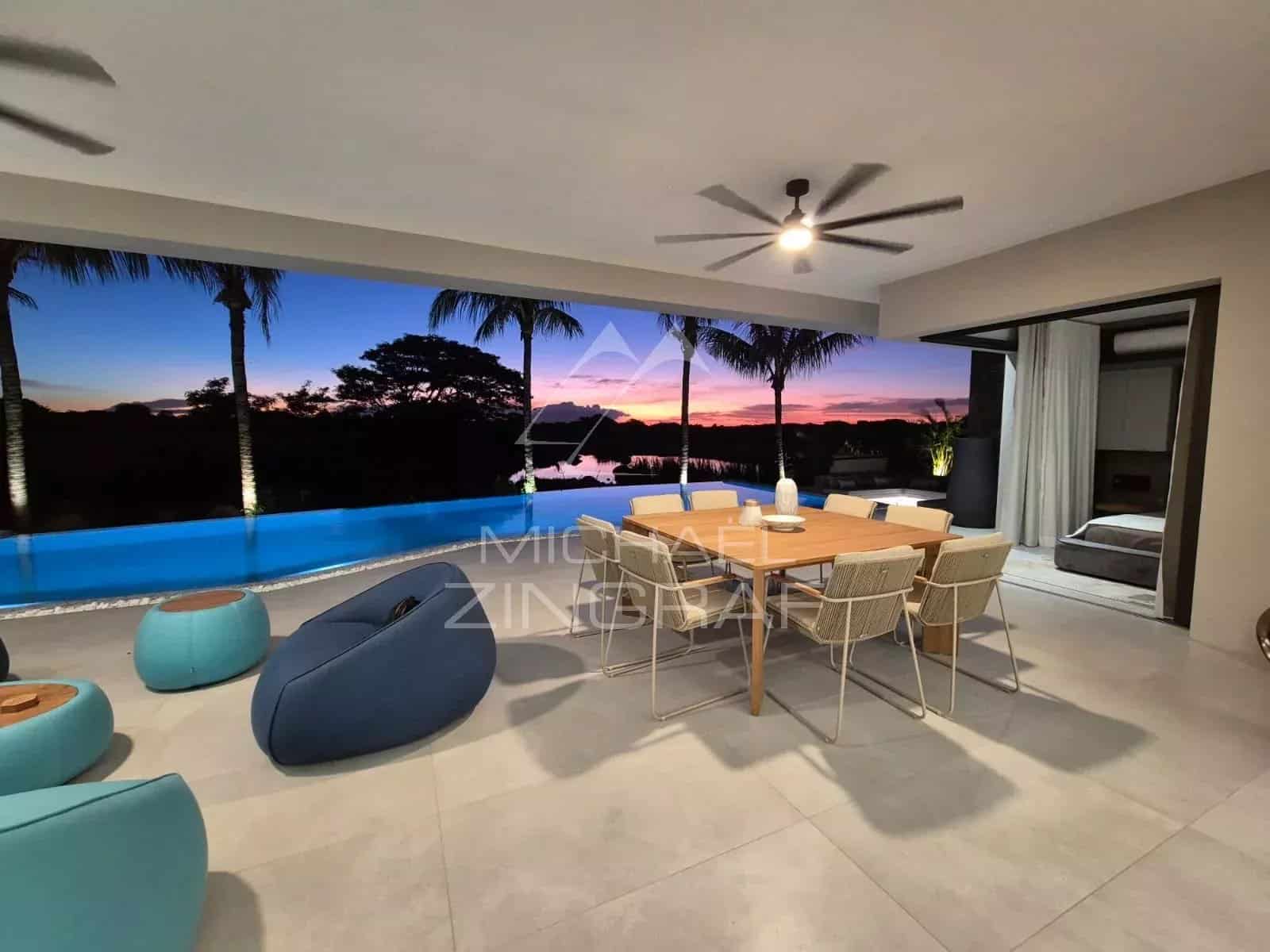 Interior of a contemporary villa with swimming pool, sunset view at Mon Choisy Golf.